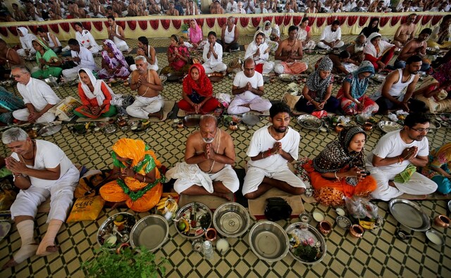 Devotees sit down to pray in Ahmedabad on the occasion of Mahalaya on 8 October, 2018. The last day of the Pitru Paksha also heralds the Navratri festival in the Hindu calendar. Reuters/ Amit Dave Devotees sit down to pray in Ahmedabad on the occasion of Mahalaya on 8 October, 2018. The last day of the Pitru Paksha also heralds the Navratri festival in the Hindu calendar. Reuters/ Amit Dave